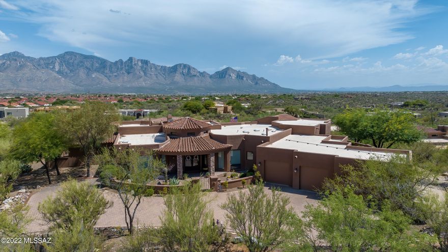 Seller will accept/counter offers between $1.5M -$1.6M. Tuscan-style beauty located in sought after Honey Bee Ridge. Enjoy unobstructed Catalina Mountain/City views from one of the highest lots in Honey Bee Ridge! Private & serene community w/ guard house. Bright & spacious 4bed/5bath (All En Suites) 2008 custom built home w/ views from every window. Well thought out floor plan w/ beamed, tray, cove & arched  ceilings throughout. Grand turret entry w/ 10' wrought iron glass door. Tastefully designed gourmet kitchen w/ island, separate step-up glass breakfast bar & Aw-mazing granite work. High-end Dacor appliances including double ovens, cooktop, finished refrigerator/dishwasher & warming drawer. Elevated & extended covered patio w/ spa, waterfall & outdoor kitchen. Amazement abounds!