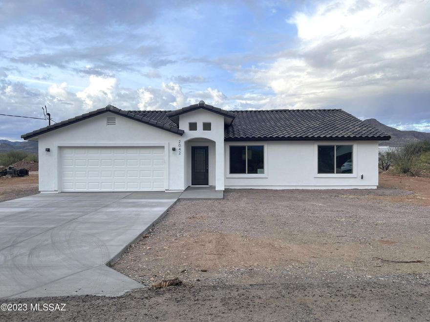 VIEWS, VIEWS, and VIEWS! New Construction-MOVE-IN READY!    This beautiful 3 bedroom, 2 bath home has an open floor plan filled with natural lighting throughout. Just off the kitchen, the open area of the living room & dining room provides plenty of space for the entire family to spread out comfortably. The home faces east/west with exceptional views of the surrounding mountains. The kitchen includes custom cabinetry, granite countertops, an island, & SS appliances. Fine upgrades can be appreciated throughout the home such as spacious bedrooms,  an oversized walk-in closet in the MB, tile floors throughout, ceramic tile in shower wall surroundings, vaulted ceilings, upgraded light, & plumbing fixtures.  Come and enjoy the great living Rio Rico has to offer. Rio Rico offers an abundance of recreational opportunities such as hiking, birdwatching, and it's nature.    This beautiful home is minutes away from the interstate for easy traveling to Nogales/Rio Rico or Tucson.