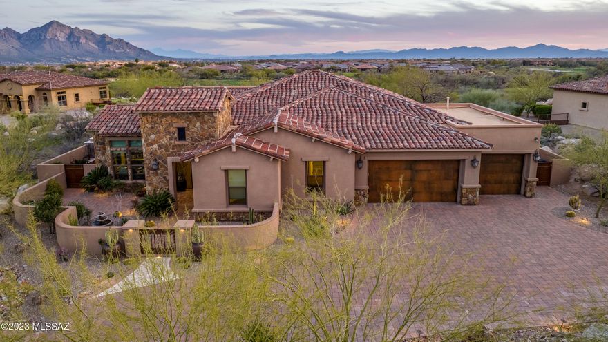 Remarkably Upgraded | Luxurious Home with Tranquil Outdoor Space. Nestled in the highly exclusive and private community of Stone Canyon Golf Club, this well design layout features 3BR/4BA, with an executive office. This residence has been meticulously designed to satisfy the most discerning style preferences. Richly fashioned with Santa Barbara architectural elements, the exterior captures your imagination with low-maintenance desert landscaping provided by talented Plants of Distinction. Unique desert species  generously effused around the grounds.   Encapsulating sheer beauty subtle glamour, the scintillating and sun-drenched interior features an organically flowing floor plan, high ceilings, a rich warm color scheme, and an open concept indoor outdoor living spaces with dramatic mountain views. 
Be inspired in the gourmet kitchen featuring 48" Range  stainless-steel appliances, a Wolf gas range with a pot filler, natural stone countertops,  oversized built-in refrigerator, custom cabinetry, a substantial center island, and upscale backsplash, tucked away and easily accessible bar with cooler drawers and stunning black granite. Fashioned for those who entertain with exacting standards, the fully enclosed backyard includes a soothing hot tub,  two patio retreats one with bistro lighting and outdoor fireplace. The Second seating area provides an outdoor BBQ, a fire pit, and builtin seating for large group seating. Pure bliss is realized in the oversized primary suite with a dream walk-in closet, and a completely luxe en suite featuring a soaking tub, a separate shower, double vanities, and premium finishes. Two additional bedrooms are abundantly sized for guests. Other features: attached 3-car garage with epoxy flooring and built-in cabinetry, laundry room, an office. Please call for a tour of the Stone Canyon Club amenities. Stone Canyon is a private golf course development continuously ranked in the top 100 Private Clubs in the Country. Membership Requirement with purchase of Real Estate.