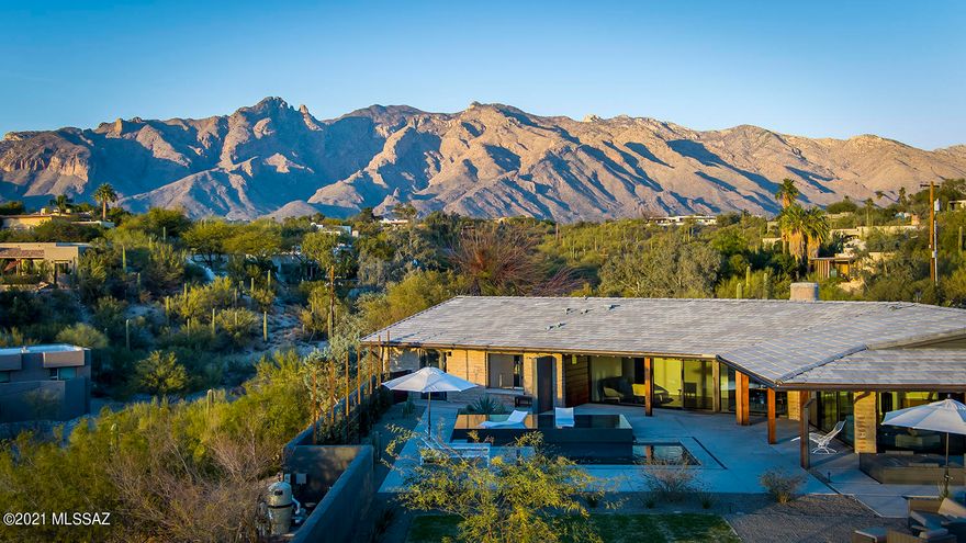 Stunning hilltop estate on over 3 acres with astonishing city and mountain views and a spectacular Saguaro grove. Gorgeous midcentury modern showpiece in prime Old Foothills location. Out of this world views and privacy yet close to U of A & Downtown. This property is in move-in, turnkey condition with modern finishes, services and amenities throughout. See upgrade list in documents for details. 

Main house features a breathtaking lofty open plan kitchen/living room/dining room/ den space with three spacious bedrooms and two and a half baths. Fireplace in living room is wood-burning.

Guest house features high ceilings, original pine floors, two BR's/ one Bath with ground-level basement incl two rooms plus laundry.