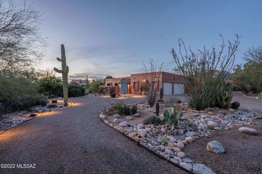A perfect blend of rustic and updated elegance, with expansive mountain views in this Shadow Hills 3BR+office stunner.  Nestled on an interior cul-de-sac in the heart of one of Tucson's most sought-after neighborhoods, this thoughtfully re-designed and expertly renovated Territorial-style gem boasts a combination of materials, craftsmanship, and embrace of natural surrounds that resonate on every level.  The glorious great room opens through double-doors to the garden and mountain views beyond.  From every angle, a hub of calm energy and an invitation to enjoy the best of indoor-outdoor living.  With an office that promises to elevate the work-from-home experience, a retreat-like primary bedroom suite, vibrant outdoor spaces, and a brightly lit 3-car garage, this one is not to be missed. (Please be sure to see full Video, and 3D virtual tour)

Glowing in warm evening light, with a perfectly balanced palette of terra-cotta, dark wood, whites, accents of blue... and the kind of vibrant green that can only spring from lush desert, this home has an energy and feel that's difficult to capture in word. With its mix of materials and natural elements, balanced with clean-lined renovations and touches inside and out, there's a unique feel here: of ease, harmony, and authenticity.  In big moments, like when one first steps through the custom steel front door, to look past the exposed block interior wall to appreciate the light and volume of the great room, and then the brilliance of the walled garden and wide mountain views beyond  .... to small moments, like sitting quietly on the round walled rear patio, under the gently rustling leaves of the graceful shade tree... there's so much to appreciate here. 

The interiors have been finished to exacting detail, with 8-foot tall solid alder doors and warm wood trim work ... framing the entry to the large office space, ideal for a dedicated office or library/den ... a hand-scraped-wood-clad beam that runs the length of the great room... and anchored with a touch of modern in the stacked-stone-faced hearth, with a hewn wood mantelpiece, a clean-ethanol-burning interior fireplace, and flanked by feature shelving and smartly finished storage cabinets.  Light pours in to fill the entry-way through a glass skylight (complete with a remote-controlled motorized shade).  Earth-toned porcelain tile flooring carries throughout the home, grounding the bright, clean, light-filled spaces with a warm, consistent, natural feel, without a stitch of carpet.  A generously sized kitchen enjoys cherry cabinetry, granite counters, stainless steel appliances, and a well-outlined work triangle between cooktop, view-door LG fridge, and triple-basin sink with a perfect view to the back patio and the garden beyond.  The kitchen and great room alike open onto a long and welcoming covered patio, tailor-made for hosting at any time of day, in every season.  

The primary bedroom suite lives like a retreat of its own, with a large en-suite bath, a walk-in closet, and a dual-use walk-in shower with linear drain, featuring a window that enjoys garden and mountain views.  Smartly designed and tucked behind sliding-rail alder doors is the laundry space, with feature-rich Samsung washer and dryer, new in 2020.  The real knock-out feature of this bedroom suite, though, is waking up to look out at the Santa Catalinas, and the ability to step out into a private courtyard patio of ones own.

The entry courtyard exemplifies the effect of old and new side by side, combining the time-worn feel and patina of the substantial wooden gate along with the modern touches of a grid-like patio, a linear water feature with copper accents and blue-tiled basin, and surrounded by beds and pots springing forth with bougainvillea, climbing vines, and flowers in bloom.   Situated as it is on the south side of the property and tucked behind a wall, this courtyard is more than just a welcoming entry -- it's a haven in winter months, especially, where one could easily spend hours basking in full sun, perhaps even while one works from a defacto outdoor office.

The back yard and garden reads even larger than it is, with a gracefully curved wall, gorgeous mountain views to the north and northeast, and a feeling of expansive openness to the west and northwest, buffered on that side with a wide interval of open property.  One on side of the garden, an elevated space with one's own grove of mature citrus.  On the other, climbing vines along the walls, and a garden shed/workshop for additional storage, garden and wood-working projects, you name it.  ....And as the centerpiece, an emerald green lawn that forms a perfect visual runway from the great room patio onward to expansive mountain views.

Not to be overlooked, though, are the thoughtful design and living features that will make living here easy, efficient, and functional.  The skylight-brightened 3-car garage, with separate workshop and mechanical closet, is invaluable as a space for overflow storage, vehicles, or even as a 3-season gym area, lighted naturally.  The systems have been delivered with energy efficiency in mind.  While the entire home is efficiently heated and cooled by a single central system, a previous owner had also made provisions to control the climate in zones, with a "mini-split" system each in the kitchen and in the primary bedroom suite.  When combined with the occasional use of the ceiling/roof mounted whole house fan, located in the kitchen-to-garage "mud room", the house is capable of being effectively cooled through the evening and early morning hours of summer days with minimal AC use.  The substantial screens covering the bedroom and office windows have, in the past, allowed for those windows to remain partially opened at night.  With the fan running in the early morning hours, the house can effectively be cooled overnight using outside air in all but the hottest weeks of the summer.

All in all, an unmatched combination of thoughtful design, natural views, and in an unbeatable location and neighborhood.