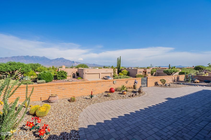 Spectacular Santa Rita Mountain views from the new patio area. Sellers replaced all windows and patio doors with Anderson Windows. Replaced exterior wood siding with stucco, remodeled so wheelchair accessible. Gutted master bathroom down to studs and redid the master bath, closet, entrance to the bath/dressing area with barn door, wheelchair accessible shower. Storage/broom closet added in master bedroom. Gutted guest bath, removed tub and replaced with tiled walk in shower. All new furnishings and deco objects included in the sale.  New washer, dryer, refrigerator, microwave. Gutted kitchen new cabinets, sink, counters, backsplash. new lighting fixtures inside and out. New carpet in guest bedroom, new closet doors. new cabinets in garage, new outdoor furniture and fire-pit.