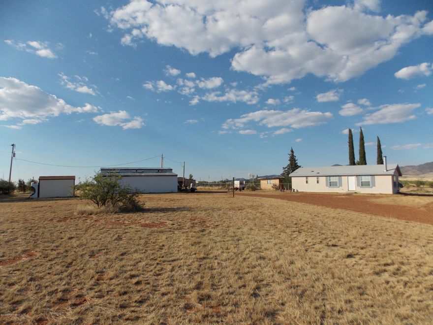 Room to roam on this 5 acre parcel with 1168sqft 2bdrm, 2ba home with a 4 stall barn and a large utility building that could be used as a shop, garage, carport or storage. 2 private wells, fully perimeter fenced with a chain link fenced backyard, The barn has a tack/feed room and stalls with runs. The home is cozy with an open great room, fireplace, laundry room, garden tub, walk in closet in the master. Come experience the best year round climate Arizona has to offer with 360 degree mountain views.