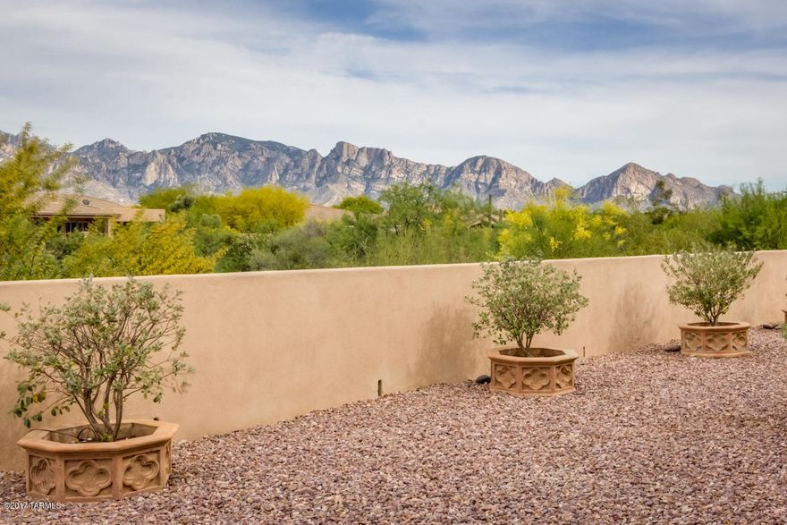 Custom 3,322sf 3BR/2BA+ 1BR/1BA Casita by Matalone construction at Vistoso Highlands-Gated 4th Green at Vistoso w/full Catalina Mountain Views. Gated Private Entry Courtyard. Fabulous Chef’s Kitchen w/Slab Granite Counters, Maple Cabinets /Pull-Outs & Spacious Walk-In Storage Pantry. Travertine Flooring & Baseboards. Living room has Raised Hearth Fireplace, Display Shelves, Dining Area w/ built-In buffet & Lighted Art Niches. Master Suite w/Raised Hearth Fireplace, en-suite w/Garden Tub, Shower, Dual Vanities & Walk-In Closet. Wrought Iron Screen Doors, Rolling Screens & Shutters, Sound System & Central Vacuum. Tons of Built-In Garage Storage Cabinets, Custom 5’x15’ Counter height Storage Unit w/double Sided Cabinets, Security System, Pool-Sized Yard w/2 Fountains. Oversized 3-Car Ga