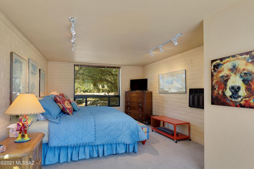 Fabulous updated burnt adobe home and guest house, designed by architect Jim Ware for his personal residence, in wonderful Skyline Country Club Estates. Spectacular mountain and golf course views framed by many large windows and sliding glass doors. Bleached wood beams enhance the bright, welcoming living room with warm fireplace. Beautiful saltillo tiled floors throughout except in the bedrooms. Updated bathrooms. Updated windows and doors throughout. Beautiful paver circular driveway. Paver courtyard between home and guest house. Recently re-plastered pool with new pump and filter. Three en-suite bedrooms and four bathrooms total. Cozy family room off the kitchen also with a fireplace. Meticulously maintained.