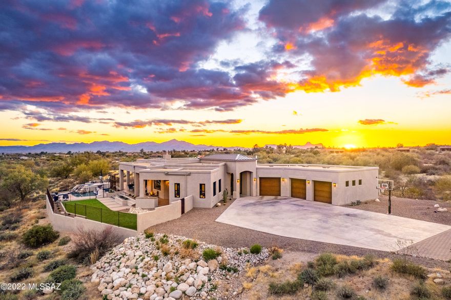 Oro Valley Custom Home Built in 2019 on over 6.5 Acres! Incredibly rare and impeccably built, this custom home has it all. Contemporary style with 4 bedrooms split floor plan, great room, gourmet kitchen, wine cellar is cooled/insulated walls, office and 3 car garage with exercise room. Outside features include: Heated pool & spa with waterfall feature, built-in BBQ, security cameras, basketball area and spacious patios with views! Interior features include: See through gas fireplace, quartz counter tops, ceramic wood grain flooring, surround sound & ceiling fans through out. Primary Bedroom has separate sitting area, double vanity and steam shower. Private location yet moments from everything. Must see to appreciate this special home! 3D tour, floor plan and slideshow available to view.
