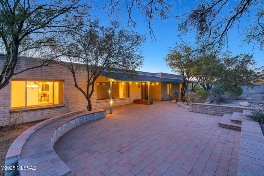 It's not just a house, it's an oasis and your day begins with the morning light illuminating the mountain view from your beautiful front courtyard with artifacts personally selected by you from  local artisans. Now it's mid day and time for a sauna break and lunch by the pool. Guests are coming, so you prepare a buffet in your gourmet kitchen and serve it in the formal dining room. Your guests are enjoying their meal while lounging in the living room, great room, and out by the pool. The evening is capped off with guests watching an ouutdoor movie while floating in the pool with their favorite beverage, or joining you in the hot tub, and the sauna! This all begins with you telling your agent you want this house before the people who just saw it get it first!