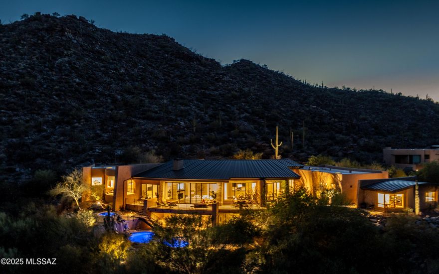 Experience a higher level of luxury w/bold style and engaging design. Meticulously crafted this custom residence promises to redefine your concept of luxury living, offering an exquisite blend of comfort, luxury and engaging design.  Floor to ceiling views . Nestled in the heart of the Tortolita Mountains - Canyon Pass at Dove Mountain brings sophistication and elegance to the heart of the Sonoran Desert.  Over 5000sf main house + a comfortable, private guest house w/separate bedroom, mini kitchen & dining/lounging area. Grand open great room concept home. Flowing indoor-outdoor living. Multiple patios, decks and exterior gathering areas, pool, spa, outdoor kitchen & BBQ areas - + mesmerizing mountain & city light views. The Epitome of Luxury Living Welcomes You. Call for private showing. Please read Highlight/Upgrade/Remodel sheet in MLS Documents to view the plethora of remodeling that has been done to this home. Fabulous value for this luxury guard gated community home.