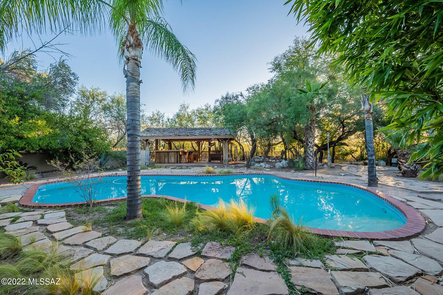 Charming Tucson Country Club home. Extensive grounds include a sparkling pool, and lush landscape. This 3bd 3bath southwestern style home is situated on a .73 acre horse property. Great for entertainment. the home also includes a palapa which overlooks the Pantano wash. Cabana that oversees pool has a sink, plumbing, and refrigerator ready to be reimagined! Don't miss this opportunity to live in one of the great neighborhoods in Tucson! Priced to sell!