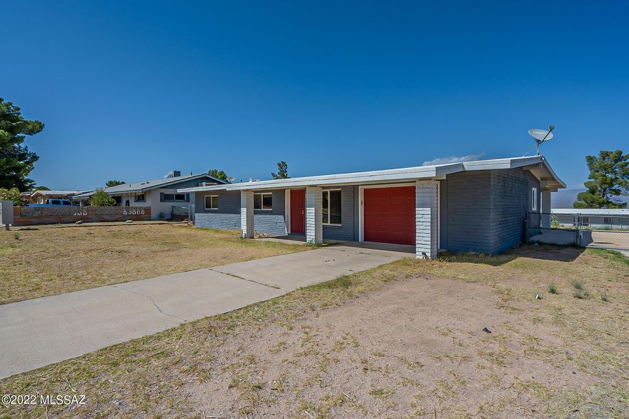 This home has a beautiful updated kitchen with quartz countertops, a tile backsplash and gas stove.  There's large tile flooring throughout.  The primary bedroom is large with a walk-in closet.  The primary bathroom has a tile shower, granite countertops and double sinks and full size bathtub.  A one car garage that features laundry and additional storage.  The HVAC and water heater are approximately one year old.  The roof is newly coated.  The home has RV hookup and back alley access.  Rear yard is fenced.