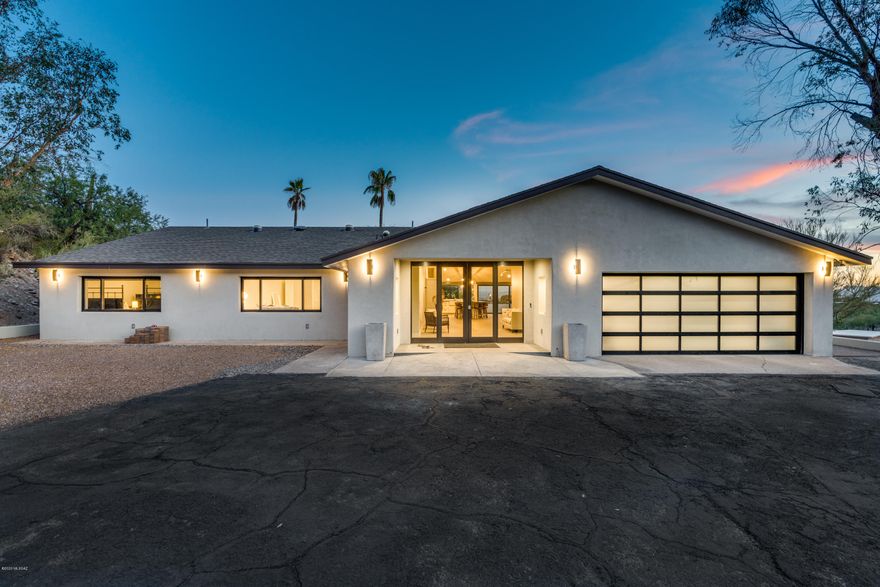Show stopper entry welcomes you into this exquisitely remodeled home where attention was paid to every luxurious detail. Large plank porcelain tile throughout, 14+ ft ceilings with exposed custom beam, gorgeous kitchen featuring Thermador appliances, double ovens, 6 gas-burner cook-top with pot filler faucet & generous 10x6 quartz island. Great room boasts multi-slide stack-able glass door that leads you to spectacular views of Tucson's glorious sunsets & sparkling downtown city lights. Well-appointed master suite with beautiful floating vanity, roll-in shower, soaking tub & dual closets. Property features 4 additional spacious bedrooms all with ensuite bathrooms. One of the four baths is ADA compliant. Custom LED backlit mirrors & electric ''smart'' custom shades throughout. Structural an mechanical improvements include: 3 new HVAC systems, new roof, new aluminum windows throughout, solid core 3x8 custom interior doors, aluminum garage door, all new plumbing & electrical, pool resurfaced, custom lighting design interior & exterior, solar tubes throughout