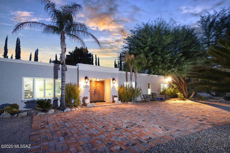 A beautifully updated Oro Valley Country Club home nestled behind soaring spruce trees on the lush 11th fairway, this property will appeal to an entertainer's heart as it blends traditional charm with sophistication. From the moment you enter the welcoming foyer you'll notice the elegant interior with updated 32'' tile and hardwood floorings. Unique lighting and draperies throughout assemble a soothing palate. With stunning Catalina Mountain views and gorgeous sunsets, this home captures resort style living at its best.
The kitchen is spacious; stainless steel appliances, double ovens, ample granite counter space/cabinets, updated lighting, peninsula seating for two and a dining area overlooking the back patio/golf course. Flex/bedroom with closets, backyard entrance and guest half bath off kitchen.
The large stone fireplace is the focal point in the deliciously comfortable family room; exposed wood beamed ceiling, built in cabinetry with granite tops. Updated sliding door leads to the oversized pebble tech pool and patio area which can easily accommodate large gatherings under those perfect desert night skies.
An extra wide hallway leads to the large owner-suite with two walk-in closets, doors leading to the covered patio and pool area. Owner's bath has walk-in shower, knotty alder cabinets and vanity seating space. Secondary bedrooms are spacious. Ceiling fans and plantation shutters in both. Hall bath has dual sinks and jetted tub. Working from home is well-situated in the private office with built-in alcove shelving, Mexican tile accents, glass French doors and beautiful mountain views. Professional photographs this week!