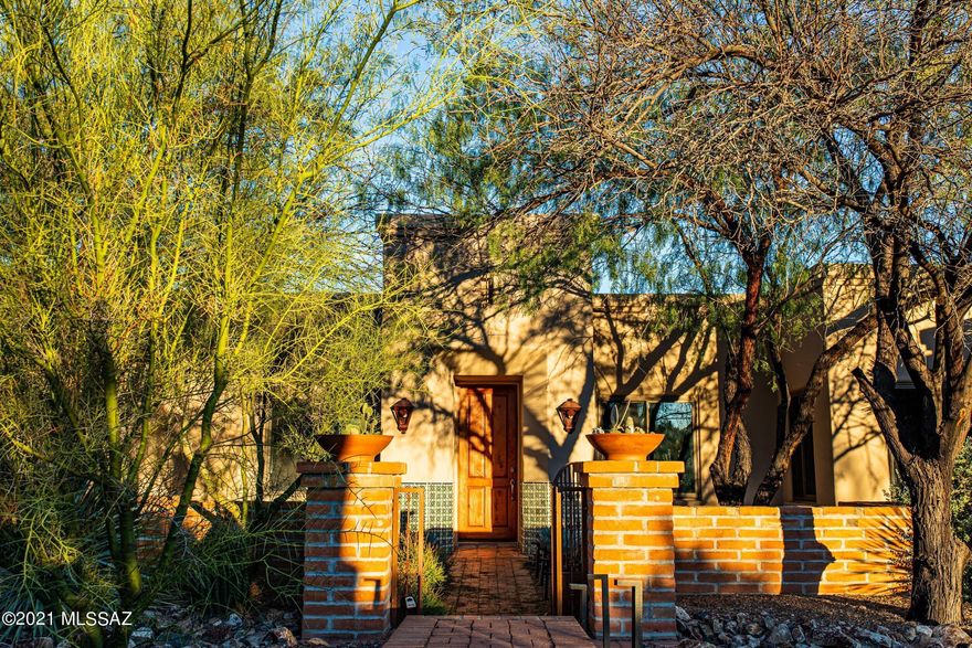 Beautiful, gated Tucson Mountain Reserve hosts this wonderful four bedroom, three bathroom contemporary home on over 3.3 acres of land. Fabulous city, mountain, sunrise & sunset views. Kitchen, bathrooms and flooring updated in 2017. Lush, private rear yard with pool and spa. Enter the property on long, circular paver driveway, which leads to private, gated front courtyard. Enjoy separate living and dining rooms upon entering the home with large windows that capture terrific Santa Catalina Mountain and twinkling city light views. Updated kitchen with stainless steel appliances, Quartz counter tops, subway tile backsplash opens to cozy family room with fireplace. Split bedroom floor plan. Large master suite with updated bathroom and large walk-in closet. Beautiful home, lot and neighborhood