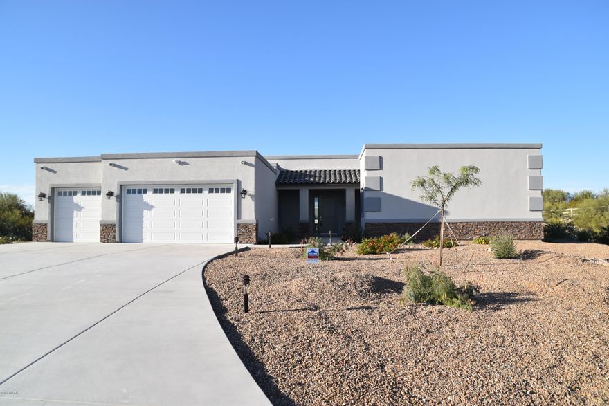 New Custom Home by Buddy Greer Homes located in the cozy gated community of Manning Camp Enclave.  This fully fenced property is 3.6 acres at the base of Saguaro National Monument East with panoramic views of all mountain ranges.  Enjoy the sunrise and sunsets each day.  This contemporary open floor plan is perfect for entertaining.  Gourmet kitchen with granite countertops; Granite Counters in bathrooms with custom tile work.  Bonus room perfect for office or library.  Lots of extra storage in laundry room.  Expansive covered back porch limited only by your imagination. Owner related to agent.