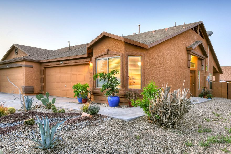 This is a lovely home with several attractive features. Owned Solar!  The fact that the home is move-in ready, with newer exterior paint and the high ceilings and natural light in the great room add to the home's spacious and airy and grand feeling, while the kitchen island and 42'' oak upper cabinetry provide ample storage and counter space. The gas stove, microwave, dishwasher, and side-by-side refrigerator make this cook's kitchen well-equipped for cooking and entertaining. The 18'' neutral tile in the entryway, kitchen, breakfast nook, and both bathrooms is both stylish and practical, as it is easy to clean and maintain. The large backyard with a covered patio is ready for your designs and the block privacy wall is ideal for outdoor living and entertaining, and the proximity to a neighborhood park is a bonus for anyone who enjoys outdoor recreation. Overall, this is a great home for anyone looking for a move-in ready, well-appointed townhome with convenient freeway access and attractive features. Two car garage! beautifully landscaped front yard! Don't miss this one its a gem!
