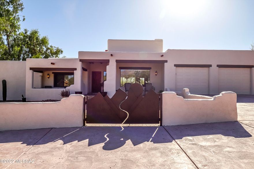 Welcome to la Hacienda. A re-envisioned Hacienda with a collection of clean walls; a visual study of its environment, where color, shape, light and shadow help create a mood of peace and tranquility in this professionally designed home. Where traditional-infused materials like the vigas and wood work promote relaxation . Once out back, you will find yourself on a huge, resort-style lanai with a built in BBQ and a romantic fireplace. The cozy, Santa Fe inspired front patio is a perfect place to relax and enjoy the mountain views and a cocktail. Once inside, you will find yourself in an architectural delight with a feeling of being in downtown Santa Fe, NM with hand carved Vigas and a light-filled family room with amazing mountain views. Down the hall is the spa-like Owner's suite.