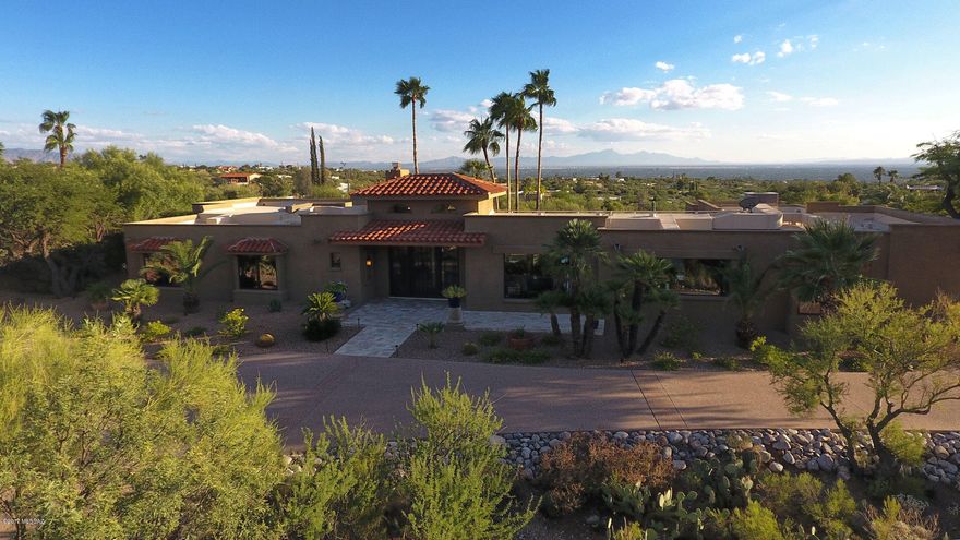 Situated on a hilltop for ultimate privacy and glorious mountain and city views, this fabulous Skyline soft contemporary home was re-designed and renovated to absolute perfection in 2015.  In 2017 new landscaping, a totally remodeled garage and other finishing improvements brings this home to a whole new magnitude. This 5 bed/4bath home features walls of windows showcasing the majestic views.  The high beamed ceiling accentuates the grand living space along with the new custom stone fireplace. The gourmet kitchen has Wolf double ovens and cooktop, Sub Zero frig, custom solid wood cabinets and granite counters.  Floor plan features a spacious guest suite with private entrance. The lavish master suite that overlooks the city has his/her closets & spa like bathroom.(CHANDLIER IN MASTER BATH D DOES NOT CONVEY) 24-inch travertine flooring throughout, custom Alder interior doors & new Pella windows & doors. Remodeled luxurious air-conditioned garage has striking flooring by Rogo, custom Cabinets, elec/plumbing for frig, wet/dry vacuum, ceiling fans, new insulated garage doors, ceiling and walls are insulated, new windows and entry door are some of the impressive features that make this exceptional showroom garage.  Please see extensive list of improvements under documents.
