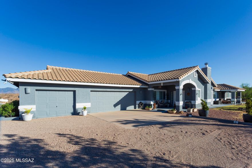 Beautiful hilltop home with panoramic views! Set on 11.4 acres, this 2,695 sqft retreat offers privacy, style & space. Enjoy ceramic tile & wood floors, a chef's kitchen with butcher block bar, gas cooktop, double oven & 2 refrigerators. Large windows fill the home with natural light & mountain views. Features include walk-in closet, spacious laundry room & built-in storage. Outside: PRIVATE WELL, patios, garden space, outdoor jacuzzi, 3-car garage, 2-4 car carport & 2 sheds. Perfect horse property on the edge of East Rio Rico & Sonoita Creek Estates. Serene yet close to town. Don't miss this rare opportunity to own a peaceful retreat where comfort meets style & nature is right at your doorstep.