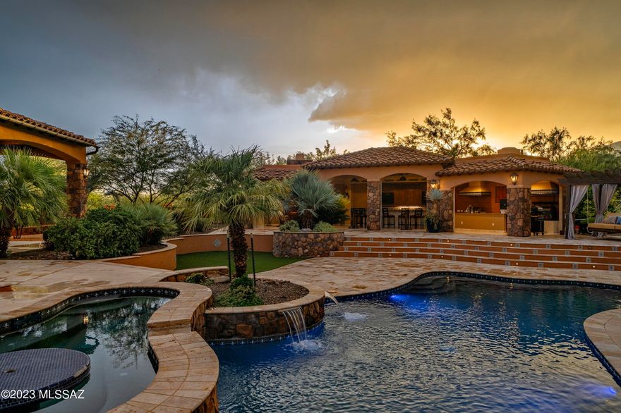 Welcome to your dream oasis nestled on a picturesque 5-acre lot, boasting breathtaking panoramic views of the Catalina and Rincon mountains. This entertainer's dream features a 995 SqFt indoor/outdoor cantina, complete with top-of-the-line BBQs and smokers, fireplace, & bath, all  perfect for hosting unforgettable gatherings. Relax and unwind by the shimmering pool and spa, or under the expansive covered patio. The elegantly designed 3700 sq ft home offers a seamless blend of comfort and luxury, featuring 4 spacious bedrooms and a chef's kitchen that is a culinary enthusiast's delight. Oversized 3+ car garage with space for two car lifts. Embrace a lifestyle of serenity in this one-of-a-kind property that captures the essence of privacy and stunning views with easy access to amenitie
