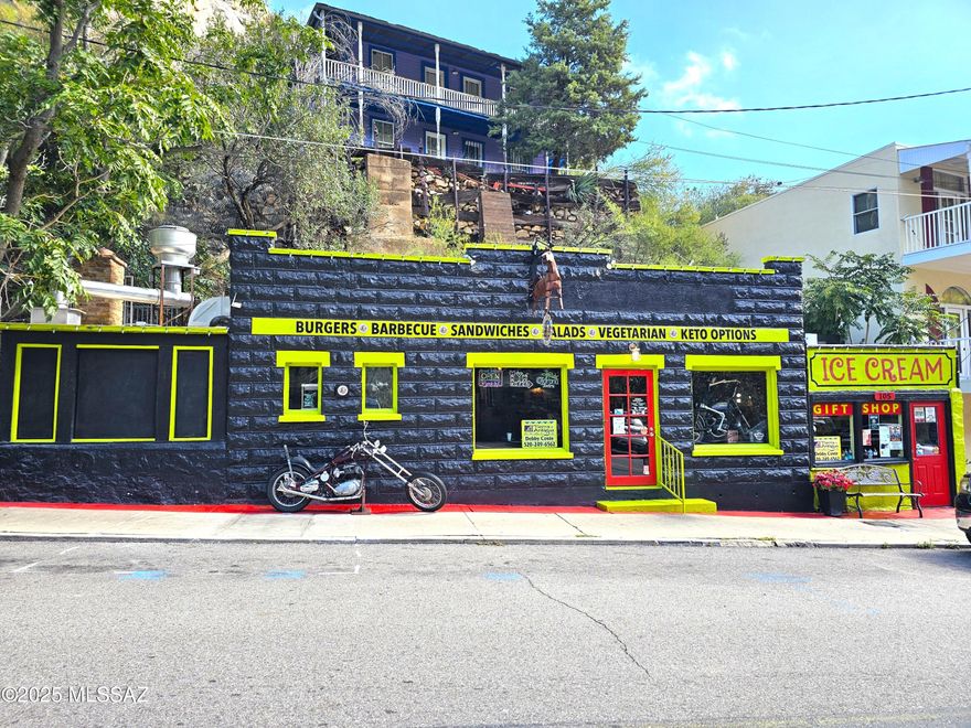 Ever dreamed of owning a piece of historic Old Bisbee? Or running your own restaurant in one of Arizona's most iconic locations? This turnkey property makes it possible—and even includes a piece of Castle Rock! The Bisbee Badassery is more than a restaurant—it's a restaurant, bar, ice cream shop, and gift shop all in one. With indoor dining, cave seating, outdoor patio space, and even a rooftop stage for live entertainment, this property offers an unforgettable experience for guests. Every major upgrade has already been completed: • Brand-new split units for climate-controlled comfort • Stunning bar and remodeled restrooms • Entirely upgraded open kitchen with all new appliances, fryers, grill, vent system, and prep tables—designed for smooth service indoors and out New plumbing, lighting fixtures,
tankless water heater, freezer, and 9 security cameras
Extras include nearly everything you need to operate immediately: misting system, Bigfoot statue, glassware, dishes, video games, display cases, kegerators, patio heaters, plus a cactus garden, 5 caves and a beautiful yellow rose tree.
This is a rare opportunity to own a truly unique piece of Old Bisbee's history ready for you to walk in and start operating today!