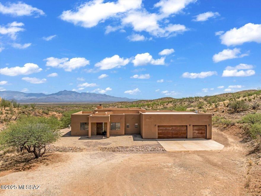 Experience true desert serenity in this stunning custom home set on 4.21 acres w/ sweeping mountain views in every direction. Freshly painted inside & out, this 3-bed + office, 2.5-bath retreat offers spacious, light-filled living w/ thoughtful details throughout. The expansive primary suite feels like a private spa, featuring a luxurious soaking tub, a walk-in shower that perfectly frames the Rincon Mountains, & a massive walk-in closet. The extra-large 3 car-garage provides ample space for a workshop or all your toys. Enjoy the peace & privacy of wide-open acreage-w/ no HOA-while still being just minutes from shopping, dining, entertainment, Davis-Monthan AFB, Raytheon, & more. W/ views from every room & ultimate privacy, this is Arizona living at its fines