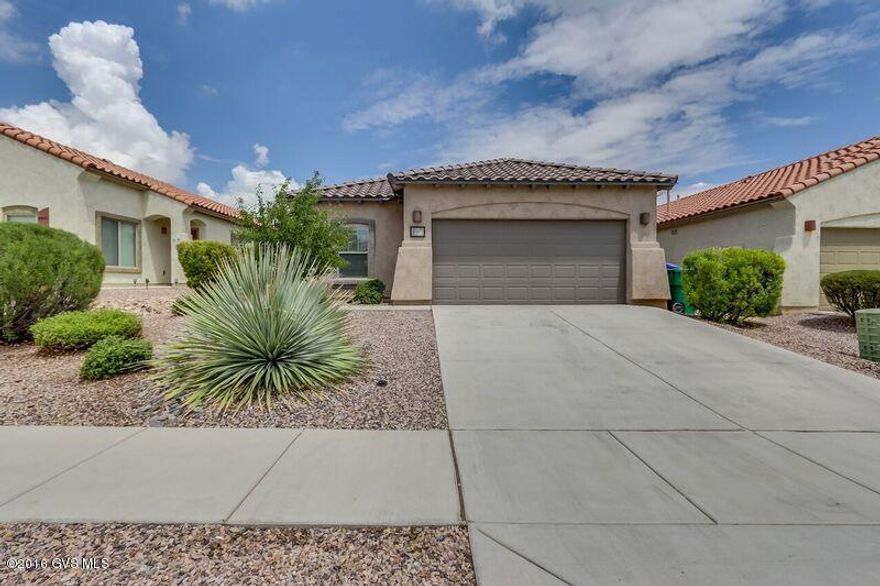 Look no further! This Karmen model by Pulte Homes, has it ALL! Immediately you will LOVE the curb appeal on this gorgeous home. As you enter, you will be overwhelmed with all this home has to offer. In the kitchen, you'll love the granite countertops, cherry cabinets with pull outs, breakfast bar and stainless appliances. Lovely kitchen nook with blown-glass pendant lights. In the formal dining and Great Room, behold the hand-scraped REAL WOOD floors and designer fans. Large Master Suite with spacious walk-in closet. Master Bath features an executive height dual-sink vanity, spacious linen closet and large shower. Two additional LARGER bedrooms (that Pulte is famous for) and a beautiful hall bath. Laundry room includes washer and dryer. Alarm system. Backyard fully landscaped for easy car