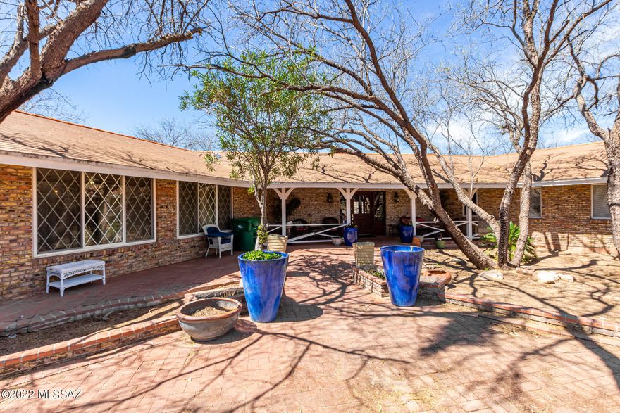 This UNIQUE property consists of 2 parcels that total 2.18 acres! Long range mountain views! Large main house built in 1977 is 3320 sq ft with BEAUTIFUL vaulted wood and beam ceilings and floor to ceiling stone fireplace! The CHARMING guest cottage built in 1984 is 1209 sq ft with brick walls/archways and fireplace! Building 3 is about 900 sq ft. 3 car garage. 6+ bedrooms and 3 baths! Swimming pool! This quiet and PEACEFUL property has endless possibilities! Welcome home!