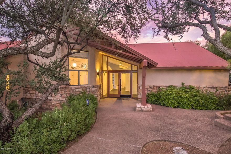 This wonderful contemporary home in Cimarron Foothills Estates is truly unique and a must see. Amenities include souring ceilings, floor to ceiling windows in living room, large kitchen with island and loads of cabinetry & counter space, living room fireplace, loft/den, large family room off kitchen, slate tile entry, multiple patios, negative edge pool, beautiful artificial turf lawn, spectacular mountain views, and beautiful lush vegetation all around. This home is located just minutes away from Sabino Canyon, schools, & shopping. In additional both the interior & exterior of the home has just been freshly painted, new carpeting has been installed, and the pool has just been re-plastered. You won't want to miss seeing this one.