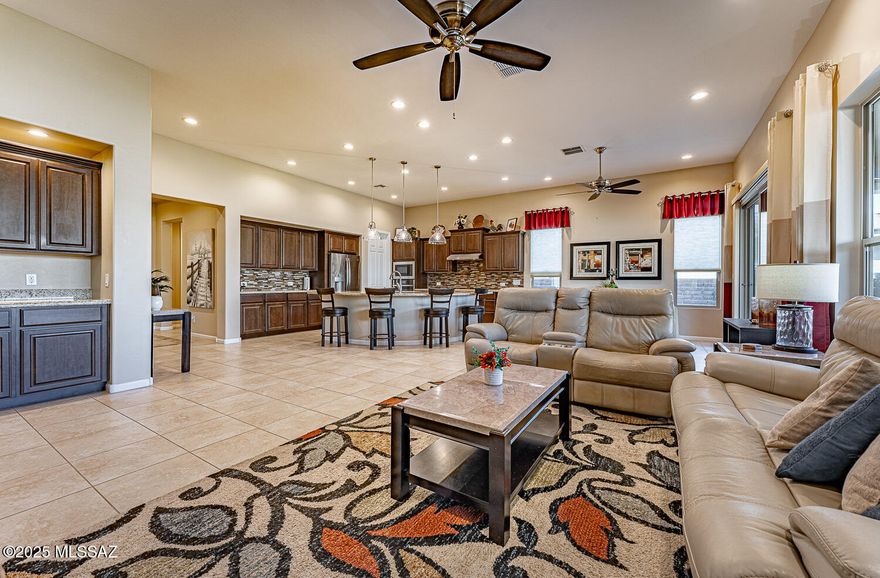 Spacious Vienta Model built in 2021 in Quail Creek.   FULL 3 car garage.
2 BR Suites 2-1/2 bath.  2308 sq ft. You'll immediately enjoy the open design, with 11 ft. ceilings in spacious great room/kitchen for an expansive and bright feel. Inviting kitchen features a curved granite island--a focal point in the room--ideal for seating, entertaining & workspace galore. Pendant lighting, walk in pantry, staggered upper cabinets w/crown molding & roll out shelves, coordinating full backsplash & SS appliances.
Great room with wall of windows and an upgraded cabinet bar for serving and storage. Large Den with coffered ceilings & glass French Doors for privacy. 
Ceramic tile in main living areas and upgraded carpet in 2 BR Suites/Den. 
Primary BR w/ coffered ceilings & extended walk-in closet. Primary Bath has a beautiful curb less shower, w/decorative tile, Delta slide bar shower head, quartz countertops w/ dual sinks and linen closet. Plantation Shutters (dining, den, guest BR) blinds & decorator curtains. 1/2 bath - w/pedestal sink. Large laundry room has cabinets, counter, hanging & closet storage too. Full 3-Car Garage with Epoxy coating and overhead storage is a dream come true!  Water Softener.  Extended driveway with pavers at sides and front walkway. Nicely landscaped yard front and back. Private, secured backyard w/ 5 ft walls, 2 decorator gates & extended paver stone patio. Low maintenance w/shrubs, lemon tree and artificial turf.  An ideal home to enjoy the many amenities in the Quail Creek Resort community.
