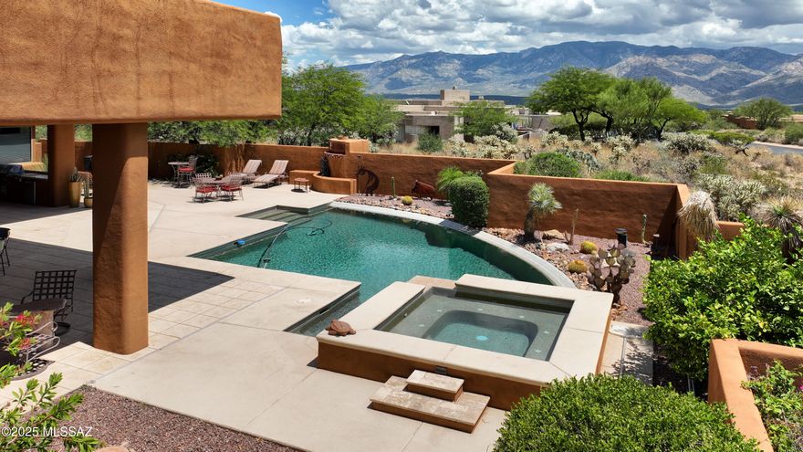 SW contemporary style home situated to capture panoramic Catalina mountain views.  The floorplan is designed for AZ living inside & out that features an open, spacious living area features a stacked stone fireplace island. Gourmet kitchen will delight any cook. AZ outdoor living at its best includes: extensive covered patio space, built-in BBQ, fireplace, sparkling pool & spa w/waterfall.  A luxury home throughout. Lot 26 across the street is for sale under a separate contract, only to the buyer of the house. Imagine designing for mother or as a family compound.  Endless possibilities to design and build OR sell on your cul-de-sac with the beautiful mountain views.