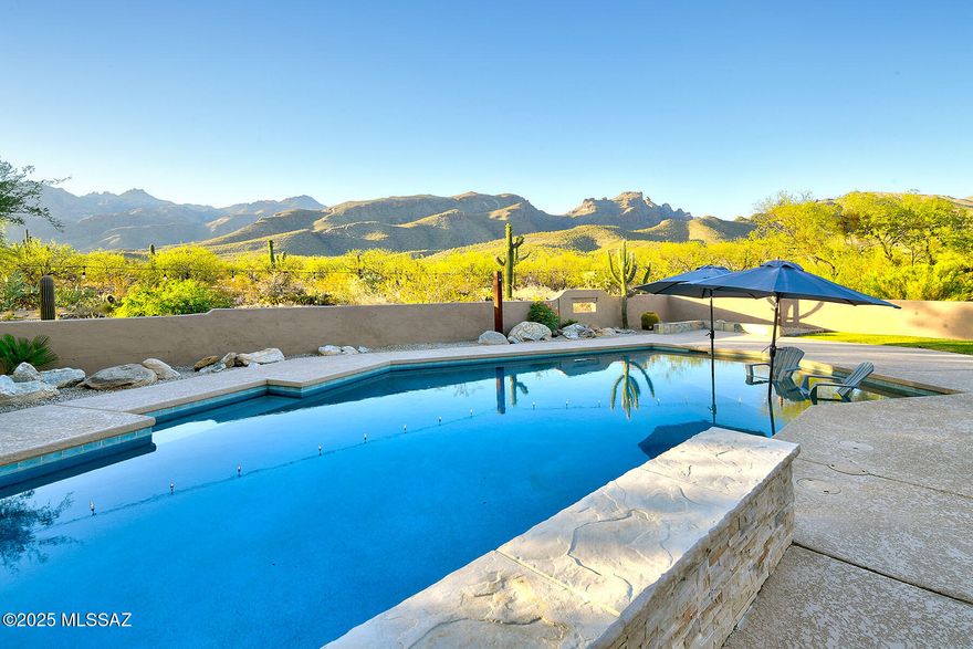 Grab some popcorn because this home has a home theater with 6 recliner chairs and surround sound speaker system! This multi-level remodeled 4 bedroom, 3 bath on 1.92 acres has the most beautiful views of the Catalina Mountains. Sit on the back patio and watch TV while enjoying the fireplace. Take a dip in the pool with a shallow water lounging area, grass backyard and no neighbors behind you because the home borders county land. 39 drawers & 29 cabinets fill this chef's dream kitchen which includes SS appliances, double ovens and 8x5 large center island. Primary bath has jetted tub, tile surround shower with bench, rain showerhead with body sprayers.  Seller is leaving outdoor sauna & all appliances including garage freezer and frig. Walking distance to hiking trails.