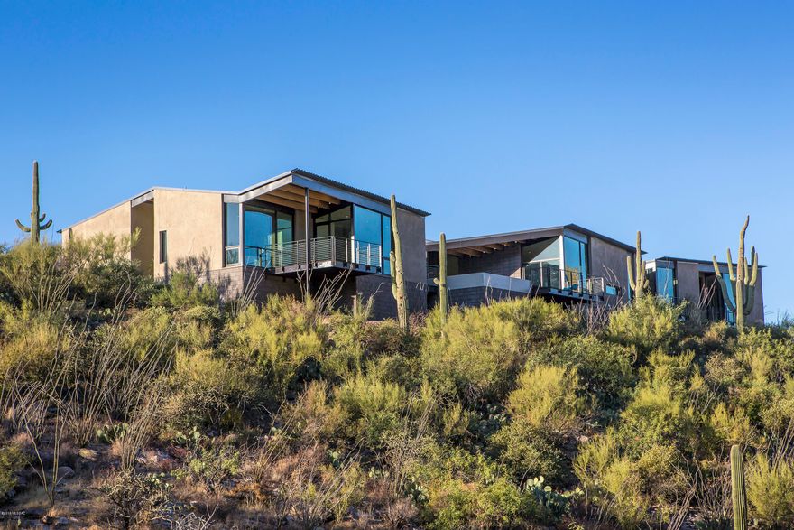 Casa de Plegado, AIA Home of the Year winner, a brand new modern home designed by Rob Paulus Architects. The unique 3.4 acre lot within the gated community of Cobblestone has amazing views, both city and mountain, and privacy, backing to the Coronado National Forest. This single level home has no steps and features a split bedroom plan with ample separate entry guest quarters, and all bedrooms are en suite. Thoughtful design features framed view windows in every room, even the hallways. Green design features include passive solar orientation, 12-inch steel framed walls with high R-value insulation, and low maintenance native landscaping. A rare opportunity to own a true contemporary at the top of this Catalina Foothills gated community.