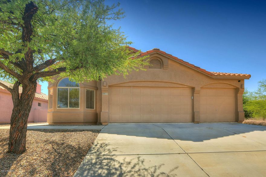 Beautiful remodeled Rita Ranch home! Upon entering you are greeted with an abundance of natural light, cathedral ceilings and a spacious great room with a warm gas fireplace. Custom kitchen has trendy cabinets with pull outs, beautiful backsplash, granite counters, island with pendant lighting & eat-in area. This 4 bedroom split floor plan features a generous master suite with walk-in closet. Easy care tile flooring, upgraded doors, baseboards, fixtures & 3 car garage with epoxy flooring. Corner lot at end of street allows for maximum privacy. Luscious landscaped back yard including grass & 2 covered patios, great for entertaining! Well maintained with newer exterior paint.