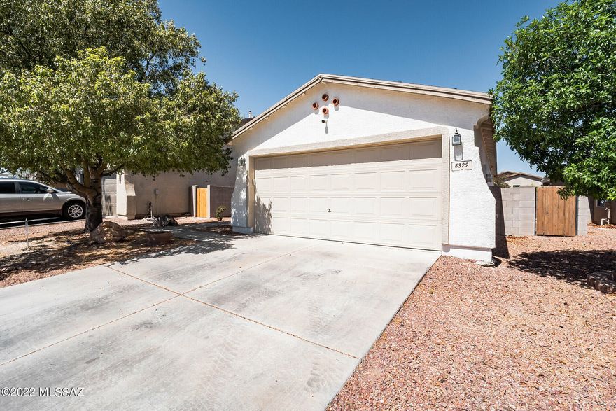 Great opportunity to own a beautiful and well maintained home.  Enjoy the open floor plan, 4 bedrooms, 2 bathrooms, living room, dining area off the kitchen, laundry room and 2 car garage. All appliances are included: Gas range, refrigerator, new dishwasher, new microwave, front loading washer and dryer. New AC with Wi-Fi controls. Spacious Primary bedroom with en-suite bathroom. Tile throughout with exception of the bedrooms. As a bonus, you will love the landscaped backyard fit for entertaining! It's fully paved with a raised planter for a beautiful garden or desert plants! Easy access to Tucson International Airport, Amazon fulfillment, I-10, Julian Wash Greenway. Make your offer today.