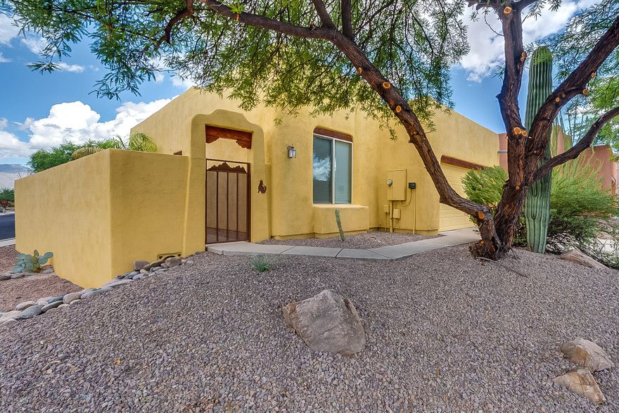 A gem of a neighborhood quietly tucked away alongside the Loop.  Good eastside location close to shopping. Peek-a-boo mountain views.  A gated courtyard entrance allows for privacy and adds a western flair.  Beautiful exposed wood beam ceiling and large picture windows in the Great Room. Lovely eat-in kitchen space.  Tall ceilings, an abundance of natural light, split bedroom plan and a very large corner lot.  The backyard is nicely landscaped.  New carpet, new interior paint, new dishwasher, new microwave and the roof was recently recoated.  HOA allows no rentals with the intention of promoting a solid community.