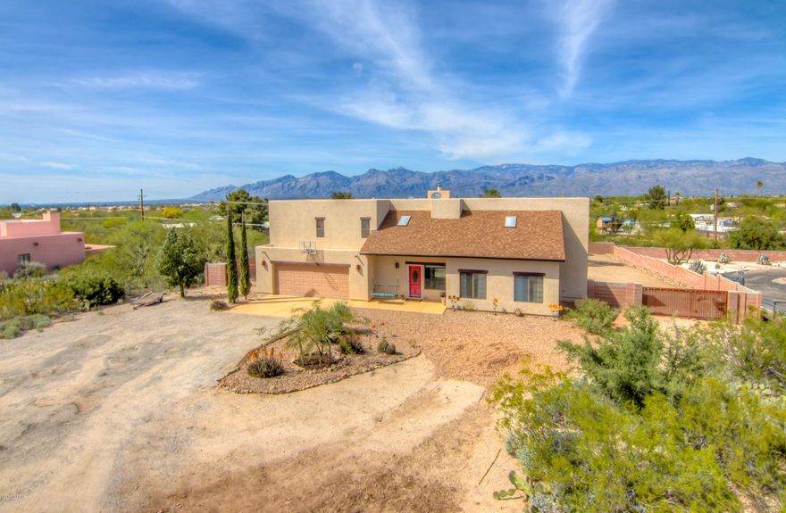 Beautiful, east side, Santa Fe style home on  an acre!  Enjoy mountain views from your private Master bedroom balcony!  Sparkling, fully fenced pool for the upcoming summer months!  4 bedrooms, 3 baths, formal dining area, 2 living areas.  Beautiful fireplace, updated kitchen and baths and new carpet.  NO HOA! Tons of privacy, close proximity to shopping and a beautiful park next door. Plenty of storage, designer touches everywhere, this home is amazing!