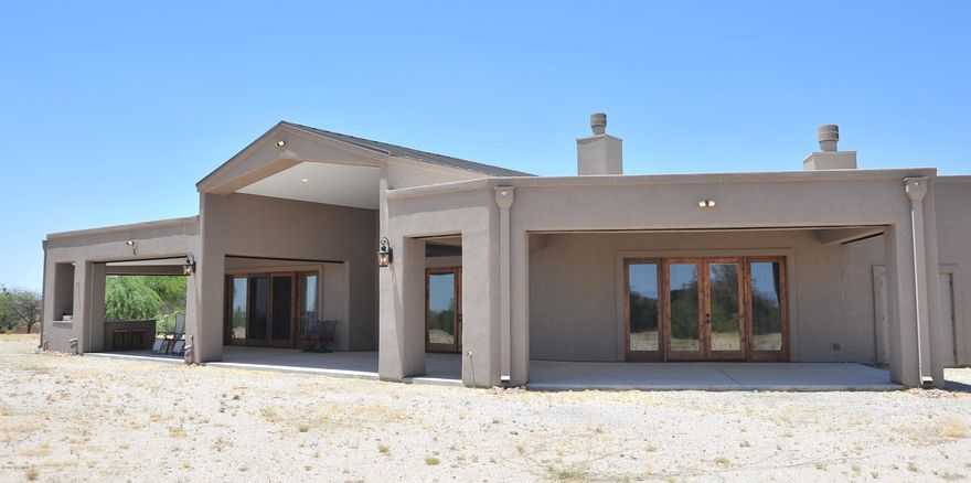 Builder lives here! AMAZING custom 4 bedroom, 5 bath 4255 sq ft behind the gate with no HOA. Just under 4 acres, horses allowed, with shared well. 50 OWNED solar panels brings the electric bill to around $20 a month! Total utilities run approx $200 a month. 2x6 construction, blown insulation, 400 amp service, LED lighting, interior sprinklers, two 50 gallon water heaters. 3 fireplaces, automatic rolling shutters on covered back porch. Custom pool & spa and outdoor kitchen to get your grill on. Great room concept with granite kitchen, 6 burner, double ovens means the holidays are at this house. 8 ft solid knotty alder doors throughout the home. HUGE bedrooms and a master closet to die for. 3 car garage with CLIMATE CONTROLLED storage. This house was perfectly built for YOU!