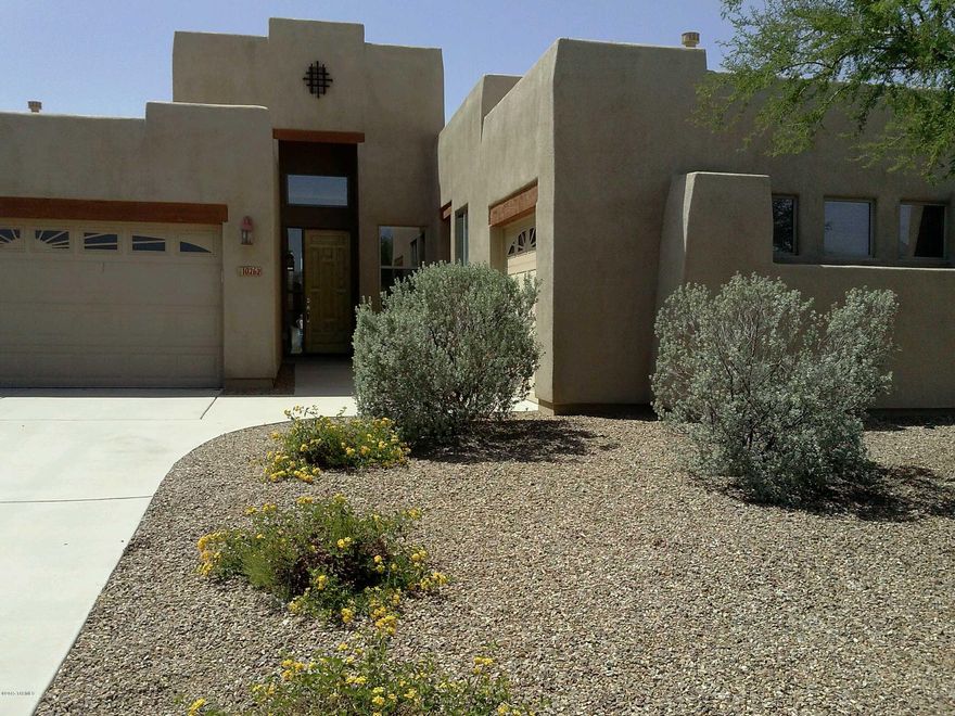 REDUCED!!! FABULOUS LOCATION! This inviting Santa Fe style home on a large corner lot in the beautiful gated GOLF COURSE community of Rancho del Lago is only a stone's throw from the golf course in one direction and the community pool in the other.The lovely interior features soaring  ceilings, a cozy fireplace, great built-ins,attractive color palatte and a spacious, bright, eat-in kitchen. The custom cabinets, granite counters and high end appliances add a designer touch throughout.Three car garage with two spaces on one side and a third on the other. Home has had exterior beautifully repainted and the roof has just recoated and resealed. Call today!!!