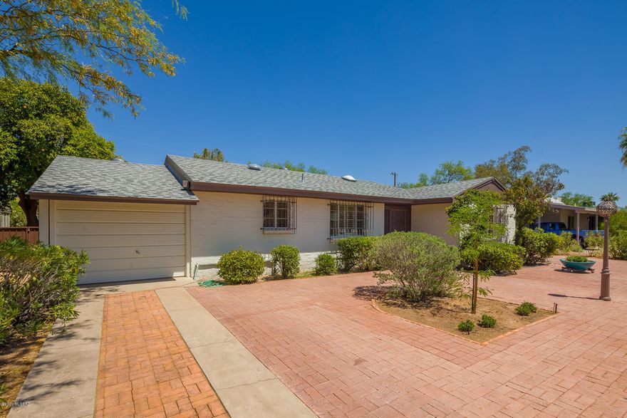 Have you been waiting for an unspoiled classic Broadmoor home? This is it! The owner has carefully brought out the original charm with some sensitive upgrades, but let most of the flavor of the '50s remain. This was a custom built home, unique in its design, and the vibe remains. From the extensive brick pavers in front and back, ceramic tile inside, the semi-upgraded kitchen, to the very cool master bedroom with a fireplace, you will love what is here, and perhaps carry on with more after the sale. The bones are great, the beautiful shingle roof is recent and the home is move-in ready.  About a mile from the U of A, the location is outstanding, and you will see your neighbors out and about, walking their pets and enjoying the sunshine or the cool of the evening. This is a must see.