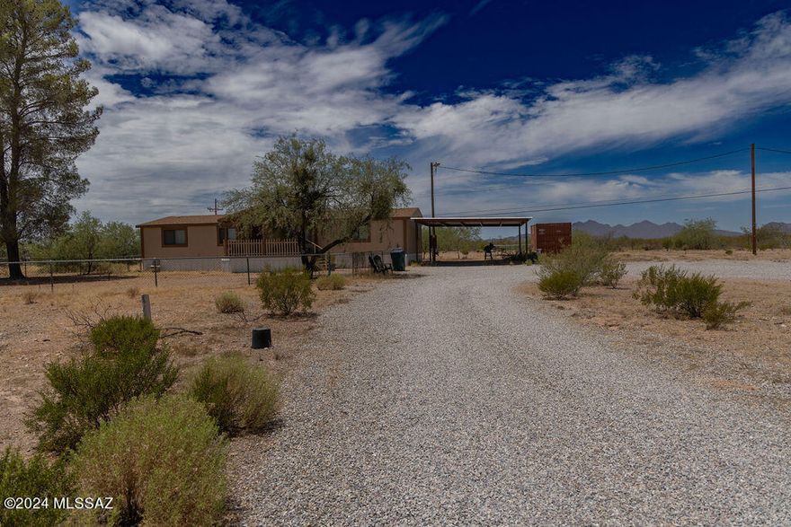 Embrace the essence of Arizona living with this inviting 3-bedroom, 2-bathroom home boasting panoramic views of the majestic Silverbell Mountains. Situated on a sprawling 1.42-acre lot, this property offers a rare opportunity to live bordering 10,000+ acres of BLM land, ensuring unparalleled privacy. The newly carpeted living area flows seamlessly into the dining space and kitchen, creating an inviting atmosphere with abundant natural light and mountain vistas.  Equipped with upgraded cabinetry the kitchen is a delight, combining functionality with scenic views. The master bedroom features a private ensuite bathroom, providing a peaceful escape at the end of the day. With 1.42 acres of land, there's plenty of room for outdoor activities, potential gardening, or even livestock. personalized amenities to enhance your lifestyle. Enjoy direct access to state trust land, perfect for hiking, horseback riding, and exploring the natural beauty of the surrounding desert landscape.  Experience tranquility and privacy in a peaceful desert setting, away from the hustle and bustle of city life