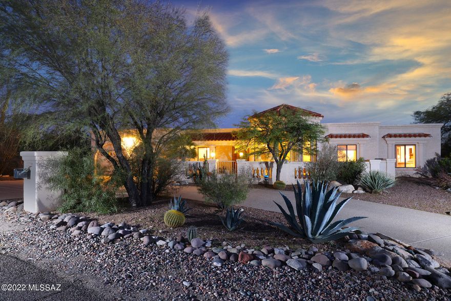 Lovely city and mountain views, an abundance of charm and spectacular location being within walking distance of La Encantada make this custom foothills home a must see.  Interior features include spacious island kitchen with stainless steel appliances, granite countertops and loads of cabinets.  Arched windows and doorways throughout, high wood plank and beam ceiling in family room, separate formal living and dining rooms, gorgeous wood and saltillo tile floors, dramatic entry skylight, master suite with office, cozy double sided fireplace, dual vanities, jacuzzi tub and 2-walk-in closets.  Outside boasts a huge covered patio, diving pool,  sport court, fireplace and multiple other brick paver patios.  All this on a fabulous and private cul-de-sac lot.
