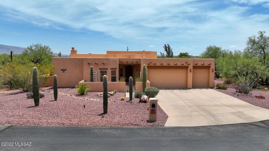 This charming Santa Fe style home is nestled on the private, one acre+, cul-de-suc lot in desirable, small, gated Rancho Camino Palo Verde community. You will enjoy spending time on extended, flagstone covered patio, walled yard w/sparkling pebble-tech pool & spa. The home features open concept kitchen with plenty of kitchen cabinets, exposed vega beams, gas fireplace, pleasant view windows. Split floor plan allows for privacy for your guests. Features include - high ceilings, ceiling fans, wooden plantation shutters, tankless water heater, waterproof laminate flooring in three bedrooms and living space, three car garage & list goes on! Den is perfect for working from home! Tanque Verde school district. Within minutes drive from golf course, hiking trails, grocery stores, etc. Great house!