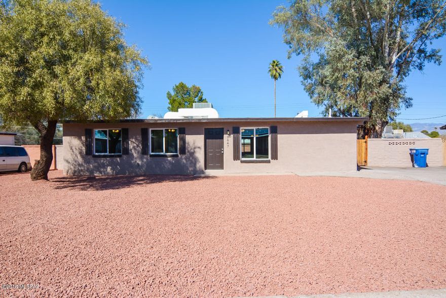 Beautifully remodeled Ranch style home. Located in a convenient East Tucson location. Charming brick construction. Rich wood laminate flooring. New modern kitchen with black appliances. New custom interior and exterior paint. New upgraded carpet in bedrooms. Completely remodeled modern bathrooms. Nice back yard with mature vegetation. Professionally landscaped front yard. Upgraded door hardware and light fixtures. This home shows beautifully.