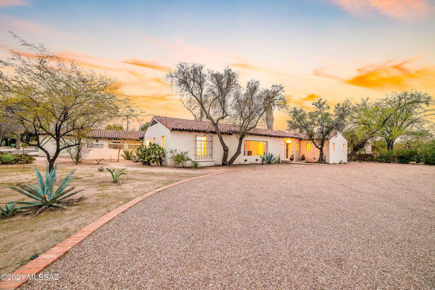This extraordinary residence in Historic Catalina Vista embodies the charm & elegance of the Arizona Inn and Josias Joesler. Local architecture enthusiasts will be captivated as they step into a home where craftsmanship, quality, and style were not optional. The polished concrete floors of the formal living room with beamed ceilings opens to a large formal dining room. Through the vintage swinging door you will make your way to the original, exceptionally preserved, butler's kitchen which adjoins a gourmet kitchen with new stainless steel appliances, multiple ovens and dishwashers, marble countertops and luxurious cabinetry - truly an entertainers dream! In the west wing of the estate you will be captivated by the handmade doors with vintage hardware, coved ceilings, multiple fireplaces, bedroom with en-suite, library (or 3rd bedroom) and a gorgeous master suite with fireplace. The centerpiece of this majestic estate is the Arthur Brown designed ballroom featuring Terrazzo floors with brass inlay and 14 foot ceilings. Floor to ceiling windows frame a luxurious pool with new old-world pavers and custom wrought iron palisade. The south east wing of the home features a "maids quarter" and an attached 2 bedroom, 2 bathroom guest house with separate entrance. This jewel of Catalina Vista is truly a once-in-a-lifetime estate.
