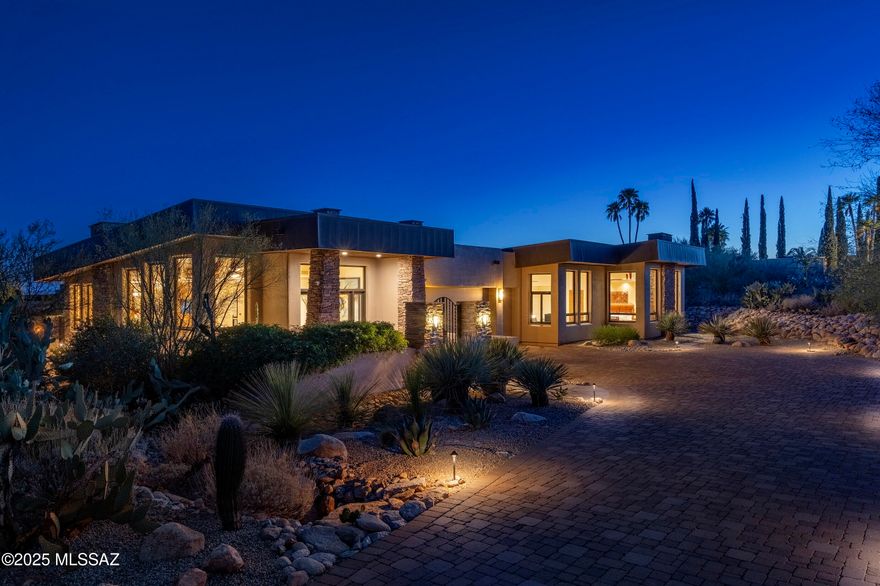 Located behind the exclusive gates of Pima Canyon, one of Tucson's most sought-after communities. This exquisite contemporary residence is thoughtfully composed and perfectly executed, offering a relaxed sophistication that speaks to those with a discerning eye for quality and an appreciation for natural beauty. From the moment one arrives, the architecture makes a quiet, yet confident statement. The entry foyer, with its soaring ceilings and sense of volume, introduces the home's contemporary yet timeless aesthetic. Clean lines, organic materials, and an effortless indoor-outdoor connection set the tone for what unfolds: a residence that lives with the ease and elegance of a private retreat. The expansive living room is bathed in natural light, where glass walls capture sweeping, uninterrupted views of the Catalina Mountains and the surrounding desert. Interiors are warm and thoughtfully curated, offering spaces that feel as suited to large-scale entertaining as they are to intimate evenings at home. Designed for both performance and beauty, the chef's kitchen features a substantial center island, natural stone countertops, bespoke cabinetry, professional series appliances and generous storage. Every element, from the layout to the finishes, has been considered for both function and visual aesthetic.

The primary suite is a world of its own, private and restorative. Framed by north facing picture windows, the room is filled with soft natural light and surrounded by views of lush native landscaping. The ensuite bath echoes calming tones and an elegant sense of restraint. A bright, versatile secondary suite, perfect as a guest room, sitting area, or office is conveniently located just off the primary. Two additional ensuite guest bedrooms are tucked into the south wing of the residence, each with direct access to the home's outdoor living spaces. 

Here, a covered veranda invites relaxed afternoons, whilst the resort-style pool and elevated spa provide a tranquil escape, perfectly placed to maximize sun, privacy, and the surrounding views. The exterior spaces are as intentional as the interiors, with multiple lounging and dining areas creating a natural flow for entertaining or quiet reflection. Every outdoor moment is elevated by the property's natural topography and graceful design, offering the ultimate in desert luxury living.  Combining architectural design with effortless livability, this residence is a rare offering, just minutes from Tucson's finest dining, shopping, and hiking, yet worlds away from the ordinary.

This home has seen an impressive series of upgrades during current ownership designed to enhance both comfort and functionality. Notable improvements include the replacement of new LENNOX HVAC units, ensuring efficient climate control throughout. The roof was recoated, while the pool and spa were fully resurfaced with new miniPebble coating and tiles, alongside upgraded Pentair IntelliCenter equipment, all with a 10-year transferable warranty. The kitchen was enhanced with a new Sub-Zero refrigerator and wine cooler, with cabinetry modified to accommodate these additions. The interior was repainted, and energy-efficient motorized shades were installed throughout. Outdoor enhancements include the repair of flagstone joints and the addition of new stone pathways, and realignment of riprap along the property's driveway.