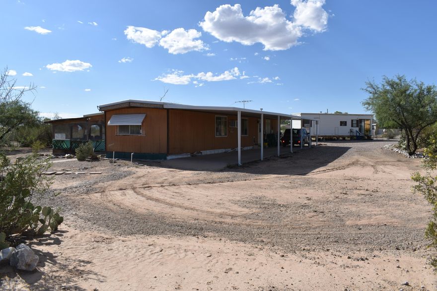 Fully fenced huge Lot with lots of natural desert landscaping. Large covered/screen in porch!  Storage Shed included! 
Charming eat-In kitchen, with pantry closet, gas range, dishwasher, and ample cabinets! 
Spacious Rooms!  Split bedroom floor plan.   One bedroom has it's own half bath. Don't forget the Huge Arizona Room! 

Bonus Structure:  1 bedroom, 1 bathroom