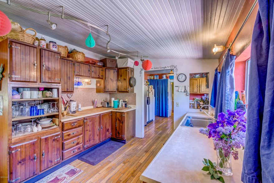 Entire Property $800,000 or $689,999 minus Upper Guest House on .5 Acres with easement through Inn as Driveway*** ~FABULOUS Corporate Retreat/B&B/Wedding & special events venue! Possible Asst Living/Retirement Community/or Apartments ~The Gardens at Mile High Ranch is a 5 star TripAdvisor property in the mountains of beautiful Bisbee, Arizona. This property boasts 5 - one bedroom suites w/ kitchenettes & 2 - one room apartments w/coffee stands, all with pull out couches, refrigerators/microwaves/wifi & can accommodate 4-5 guests. The 8th suite is a therapy room or can be turned into a suite. Large main 2 BR home & office as well as a 2 BR Guest House. The beautiful setting is perfect for large weddings & corporate events as well as space to add more lodging & special events buildings. $689,999 Price does NOT include upper Guest house. Total land now 1.18 at $689,999 or purchase the ENTIRE property for $800,000 The Gardens at Mile High Ranch is high-desert country with two acres of lush gardens, wildlife, and beautiful 150-year-old cottonwood trees. BLM wilderness is located just beyond the boundary lines for excellent birding, hiking and soul searching.

The Gardens is located in The Historic District of "Old Bisbee", and offers peaceful evenings and star lit skies. Perfect location where a car might not be needed for restaurants, shopping and Bisbee's nightlife entertainment.

Most of the property is run by solar power, so bills are quite low.

The Gardens at Mile High Ranch was built in 1920 and includes many renovations & founded in 2001 as a B&B. It has two acres of lush and wonderful gardens that will take your breath away. A large concentration of wildlife surrounds the whole area, accentuating the experience that you can get. Additionally, a large stretch of 150-year old cottonwood trees beautifies the whole place. If your heart yearns for peace and relaxation, you can never go wrong with The Gardens.

The full amenities that you can currently experience at The Gardens are bed and breakfast, private baths, greatly furnished kitchens, cable TV, two acres worth of fantastic view, wireless Internet, healing and relaxing spa treatments, massage services & body detox services, outdoor event area, and birding/recreation opportunities.

The eighth suite is currently a massage and therapy space and can be easily covered into an 8th guest suite as it was prior.

Multiple fruit trees include: 7 apple, 5 peach, 3 pear, 1 fig, 2 plum, 2 pomegranate and others...
Property is approximately 2.8 acres total***

Calm your busy mind and soul at The Gardens at Mile High Ranch. This opportunity to own this incredible property will not last long!

Previously assisted living/retirement community. Can also be apartments -buyer to confirm uses with the City and County.
Proforma number incorrect. Buyer to verify all sq. ft., Taxes, acreage and anything important to them.

If Split, an easement running through the side of the B & B will be recorded as a driveway to the Upper Guest House.

***$689,999*** New Price does NOT include upper Guest house. Total land now 1.18 at $689,999 or purchase the ENTIRE property for $800,000***ENTIRE PROPERTY SOLD AS IS***

Buyers to verify sq. ft., acreage, taxes and acknowledge that an easement will be recorded for a driveway to the upper Guest house if not purchasing the entire property.