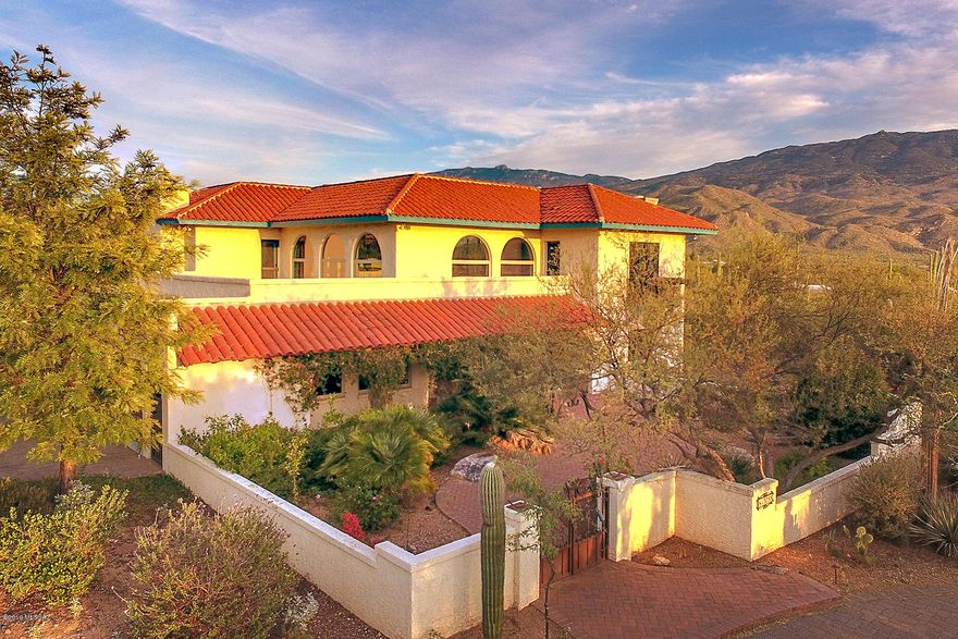Magical Southwestern home on 3.3 acres in exclusive La Cebadilla Estates. Updated in all the right places, w/custom hand painted murals & finishes. New open kitchen w/stainless appliances & whimsical touches from the mesquite breakfast bar to the colorful Mexican tile work.  Great entertaining spaces inside & out, showcase walls for artwork in living rm. Grand staircase takes you to the 4 bedrooms-2 ensuites. Generous covered porch across the back overlooks Reddington pass & hundreds of saguaros. Outdoor entertaining with pool/spa outdoor shower, kitchen, firepit, fireplace, view fencing and privacy. Guest house/mother in law/studio? your call.
