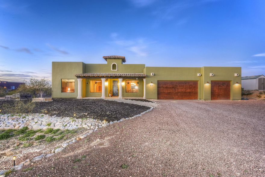 Choice lot in the award winning Vail School District. No HOA! Panoramic mountain views both front and back! Room to park an RV and the garage is AWESOME! 3 car garage with extended, 8 foot, doors for the taller vehicles, plus the 3rd stall is extended with a work space area complete with workbench. Inside you'll find a split bedroom plan, polished/stained concrete floors, travertine surrounds showers and tubs, alder cabinets in the kitchen and a great room for quality entertaining! Sellers are offering a home warranty with solid contract. This one is a gem. Do Not Wait!!!