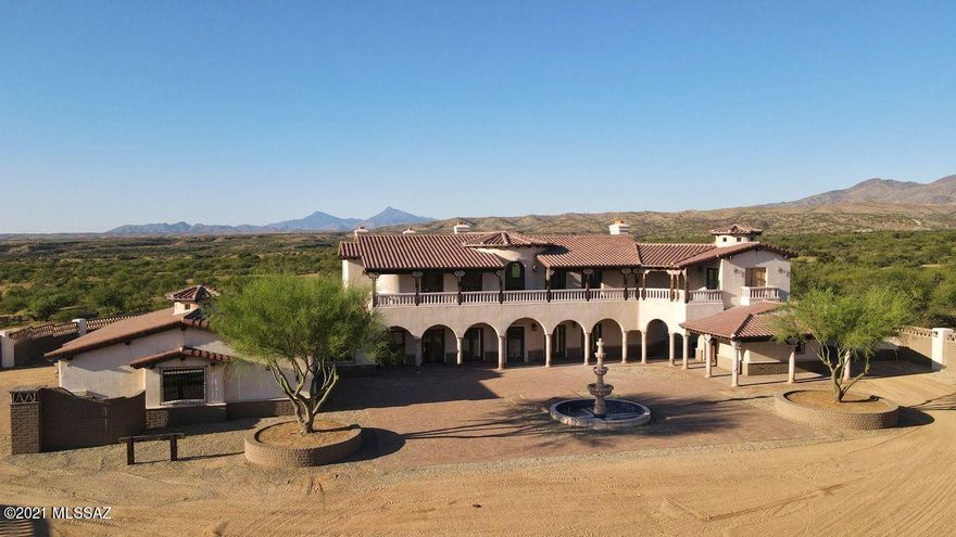 You MUST tour this remarkable 36 acre custom estate at Kino Springs inside a magnificent entrance gate & fully walled compound. Dramatic architectural design with 5 spacious bedrooms & 6 baths including a charming guest casita. Incredible massive high brick coved ceilings, artisan wrought iron work & phenomenal custom light & plumbing fixtures throughout. Temperature controlled wine room, 2 master suites, theater room, maids quarters & an oversized 3 car garage. Serene privacy, 360 degree views & perfect annual climate at 3,800' elevation. Ample room for horses & facilities. Private well, underground electric & excellent access. Kino Springs Golf Course, National Forest & the Nogales International Airport are just minutes away. Substantially below replacement cost. Possible trade.